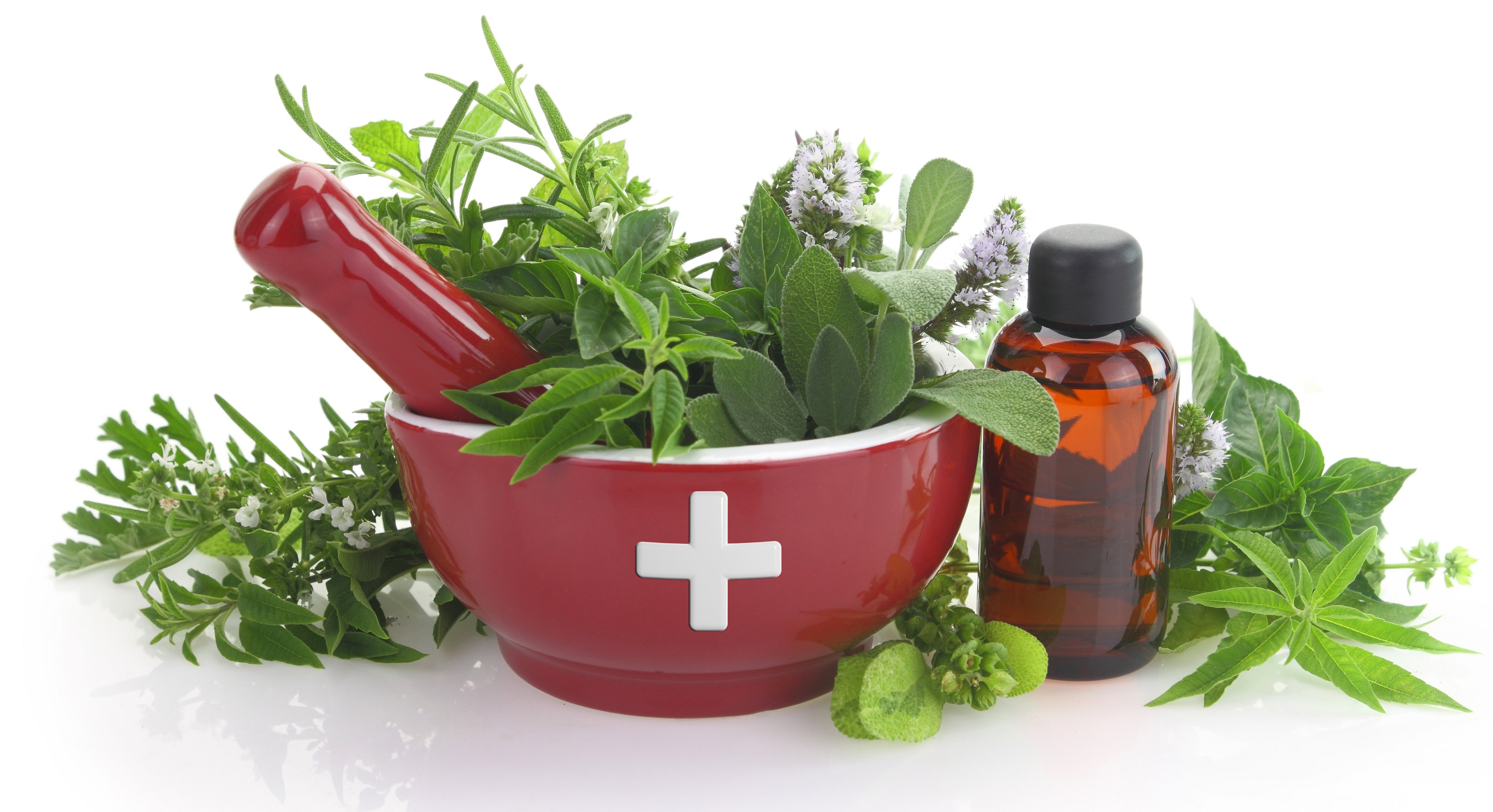 Mortar with medicine cross, fresh herbs and essential oil bottle